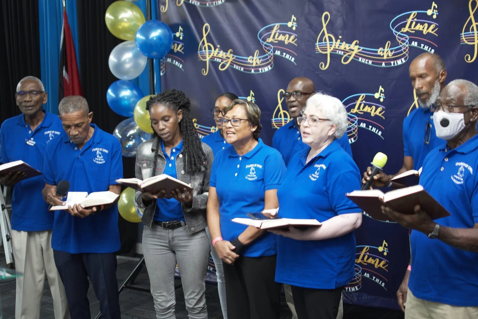 Group singing in blue polos